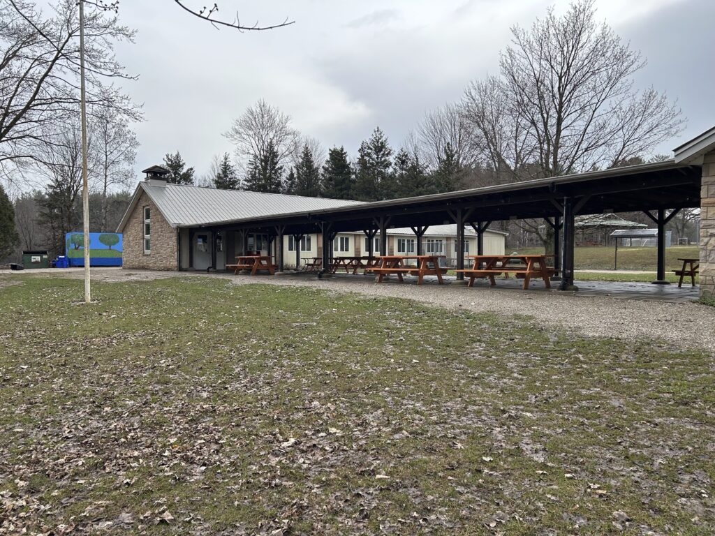 Large covered picnic pavilion at Stevenson Children’s Camp used for meals and group activities in an outdoor camp setting.