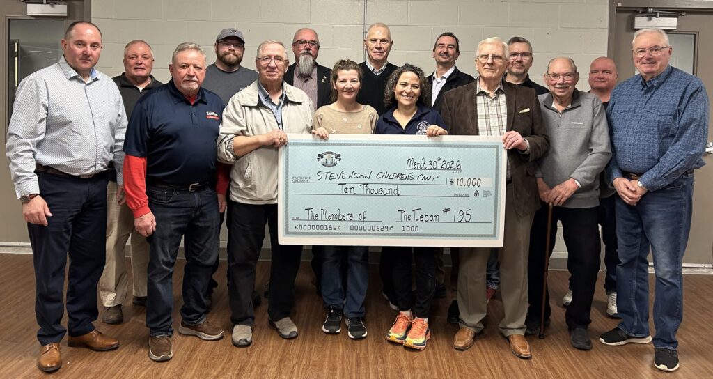 Members of Tuscan Lodge #195 standing with Stevenson Children’s Camp staff during a cheque presentation, showing community support for children’s camp programs.