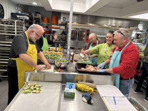 Tuscan Lodge No. 195 volunteers cooking and serving dinner in a kitchen at Ronald McDonald House Southwestern Ontario.